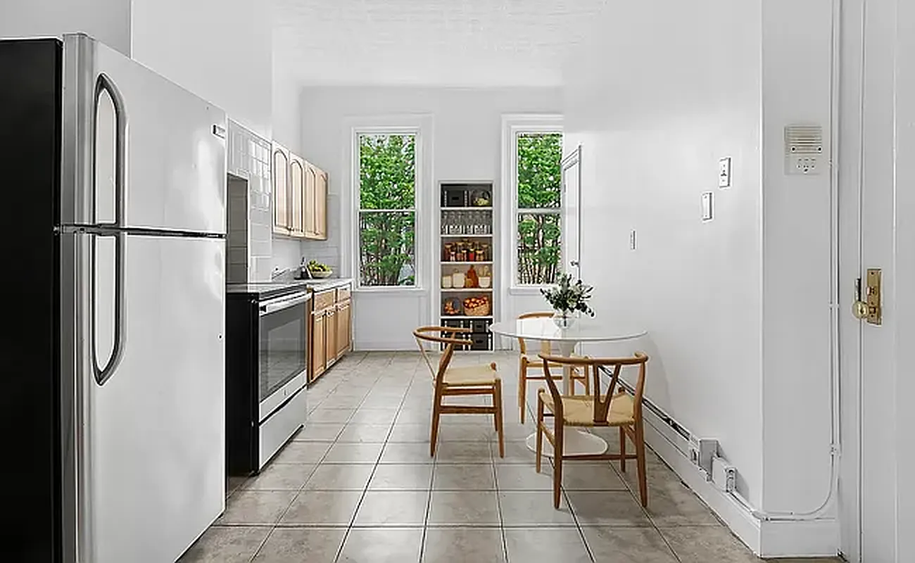 a kitchen with stainless steel appliances a refrigerator and a table