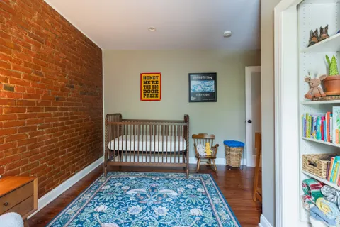 a view of a hallway with workspace and a window