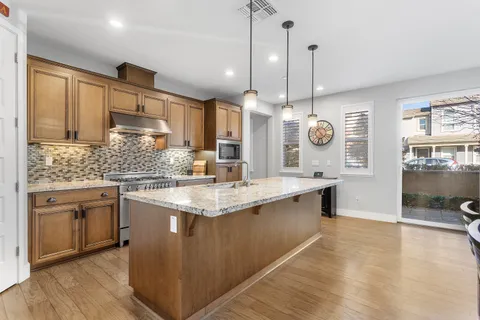 a stove top oven sitting inside of a kitchen