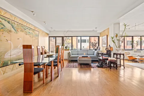 a living room with fireplace furniture and a large window