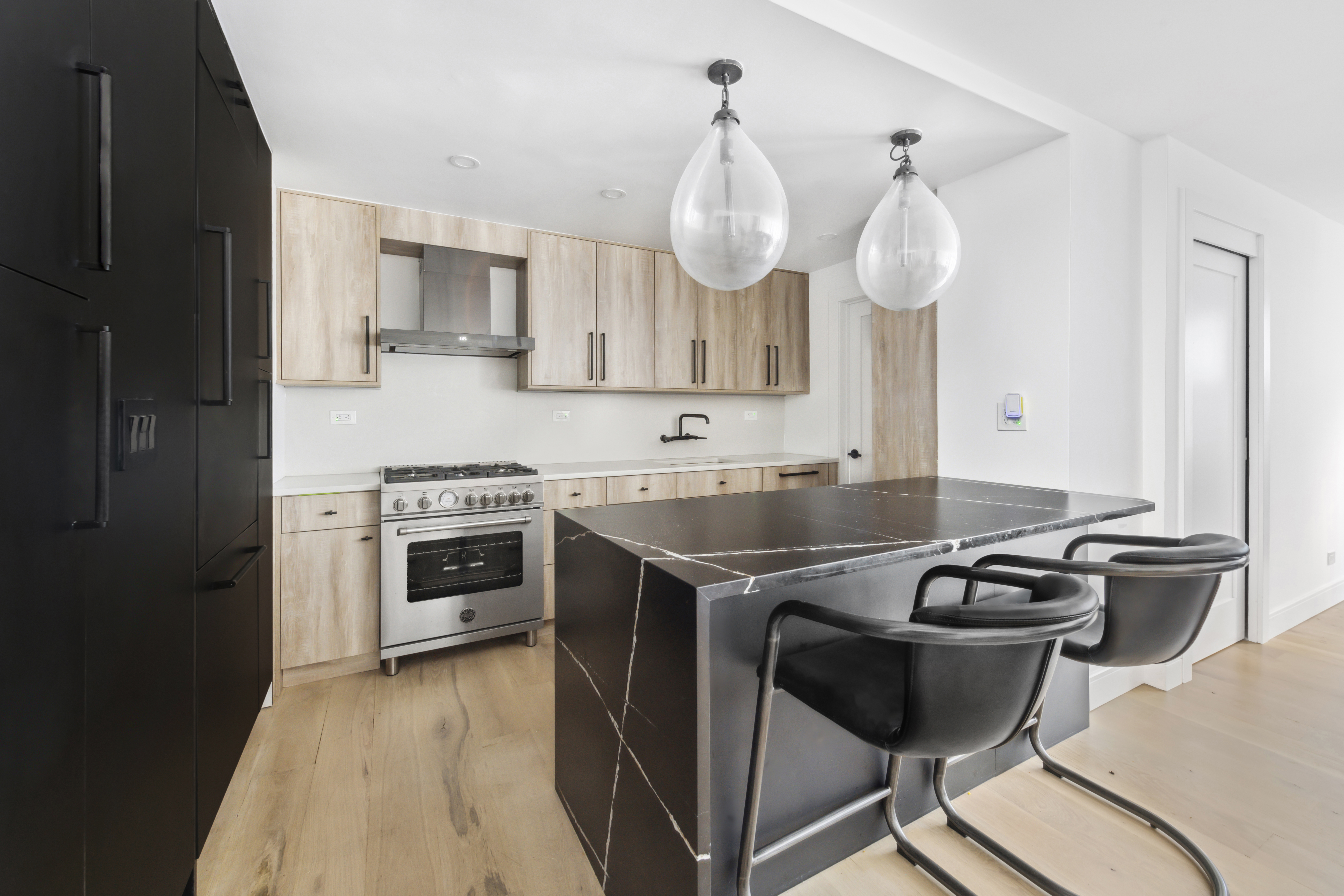 225 East 57th Street, Unit 14E Manhattan, NY 10022 - Photo 4 of 10 a kitchen with stainless steel appliances granite countertop a sink a stove and refrigerator