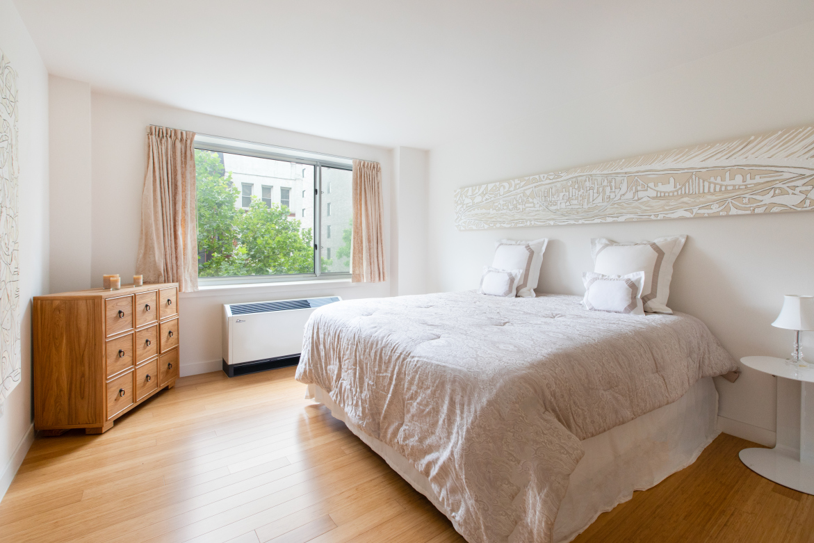 40 West 116th Street, Unit A406 Manhattan, NY 10026 - Photo 6 of 14 a bedroom with a bed and a large window