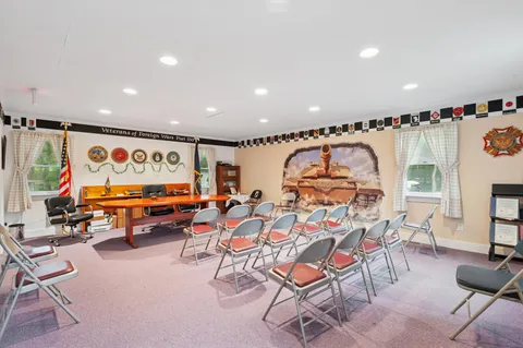 a living room with furniture a rug and a flat screen tv
