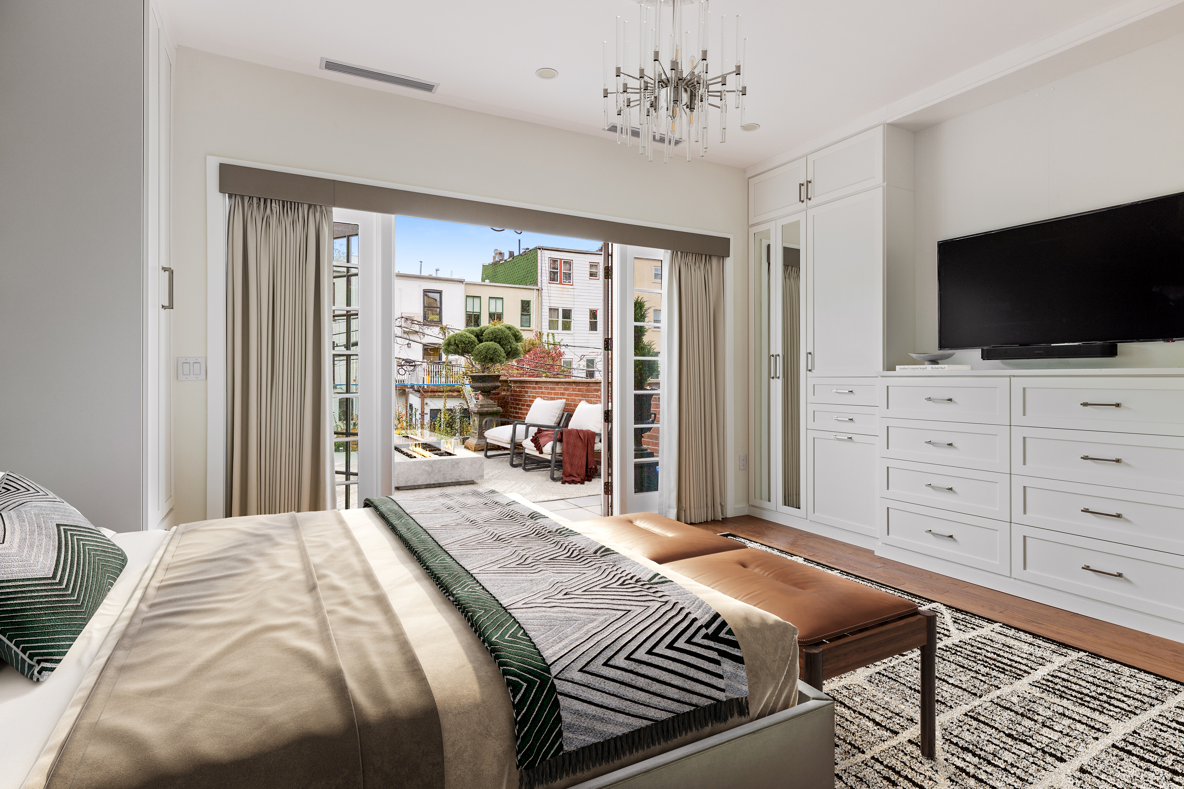 185 Bainbridge Street Brooklyn, NY 11233 - Photo 9 of 23 a bedroom with a bed and a flat screen tv