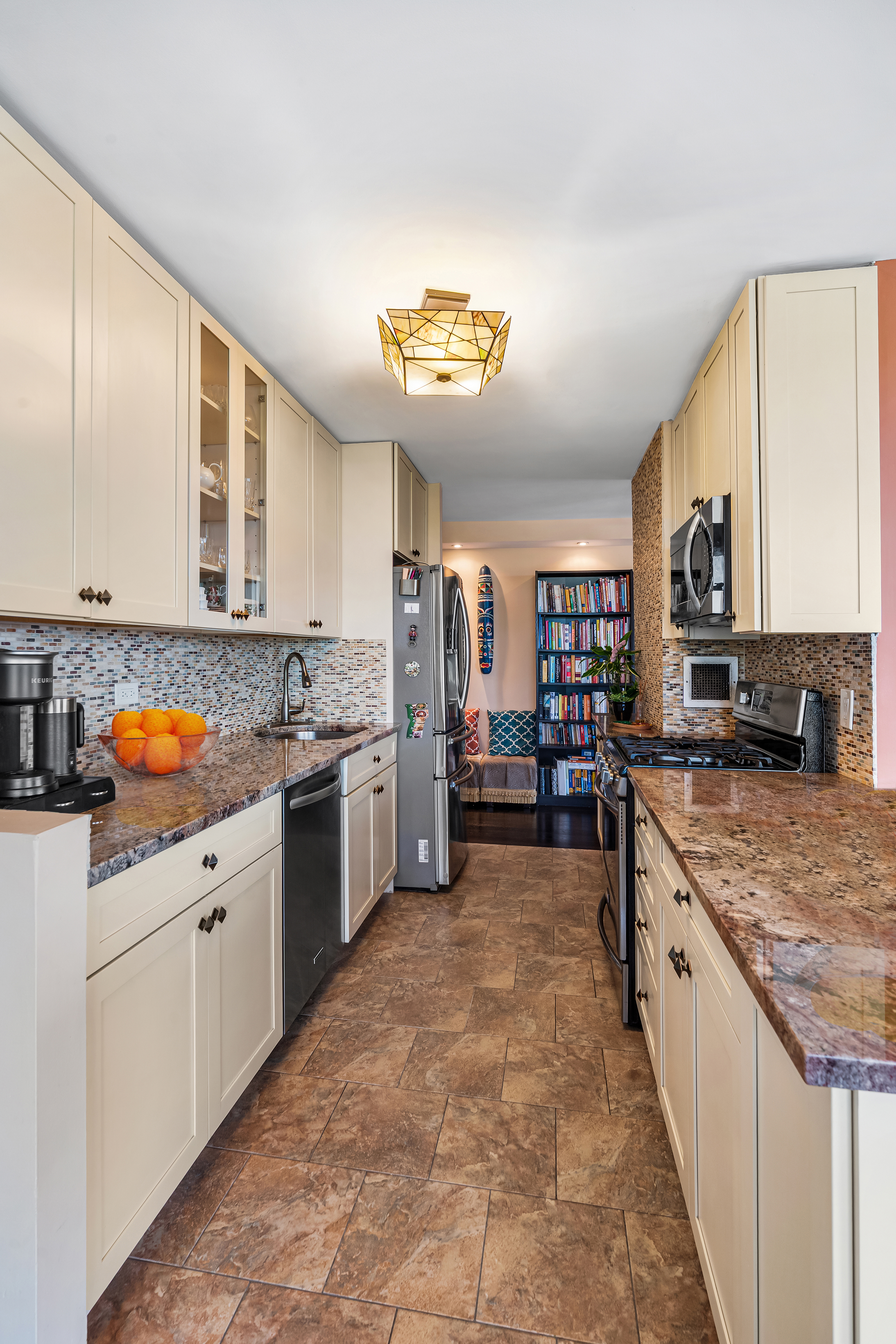 112-01 Queens Boulevard, Unit 6J Queens, NY 11375 - Photo 5 of 29 a kitchen with stainless steel appliances granite countertop a stove sink and cabinets