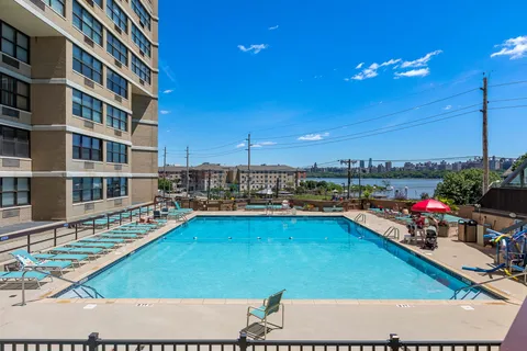 a view of a swimming pool with outdoor seating