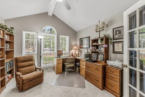 a view of a livingroom with workspace and a window