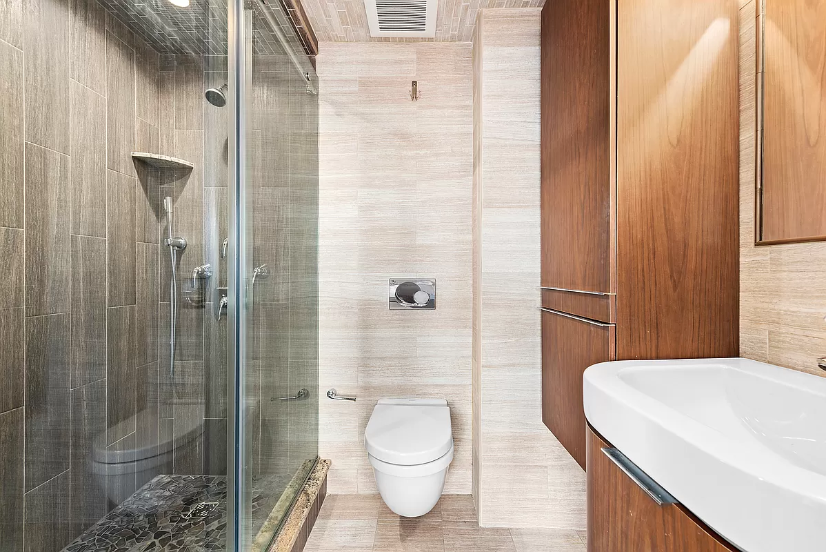 300 East 93rd Street, Unit 14F Manhattan, NY 10128 - Photo 10 of 14 a bathroom with a toilet and a shower