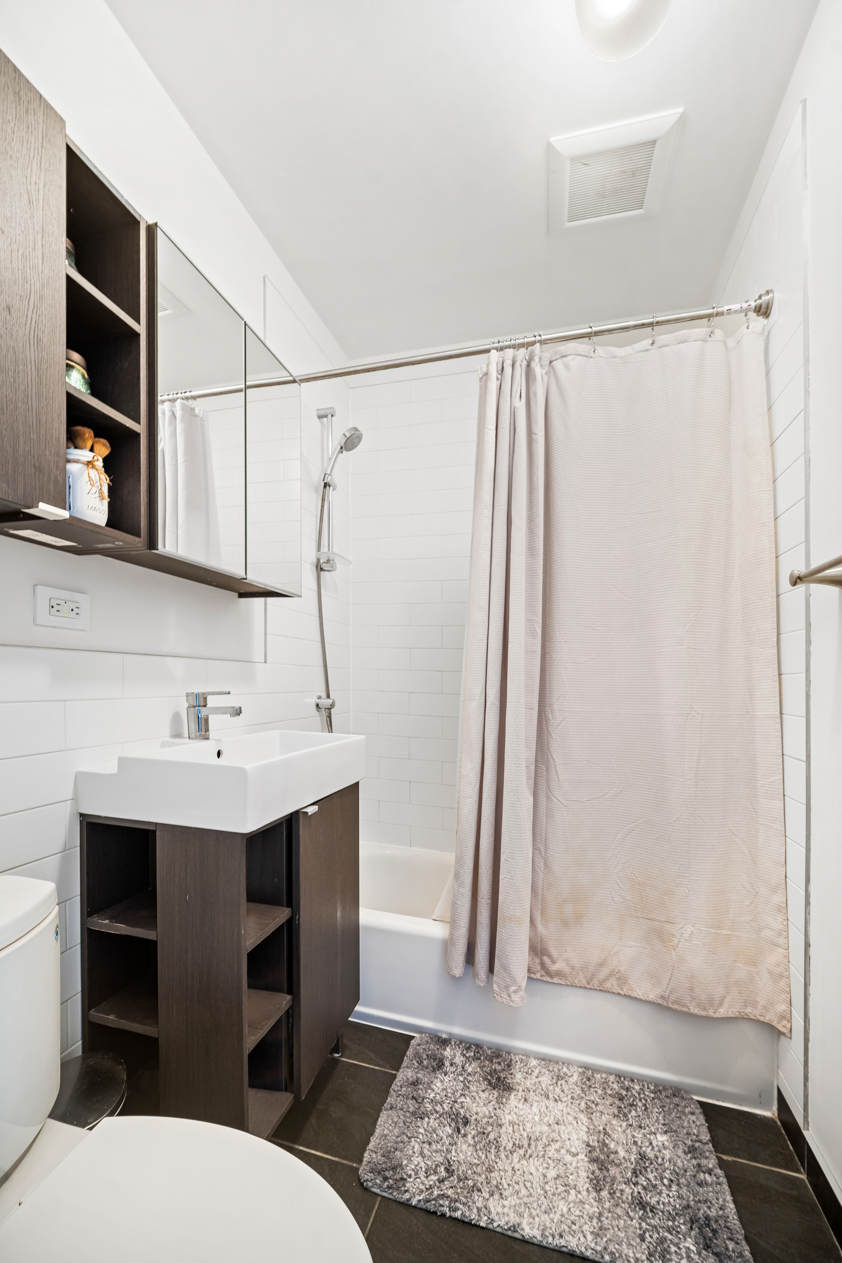 65 Jackson Street Brooklyn, NY 11211 - Photo 32 of 36 a bathroom with a sink a toilet and a shower