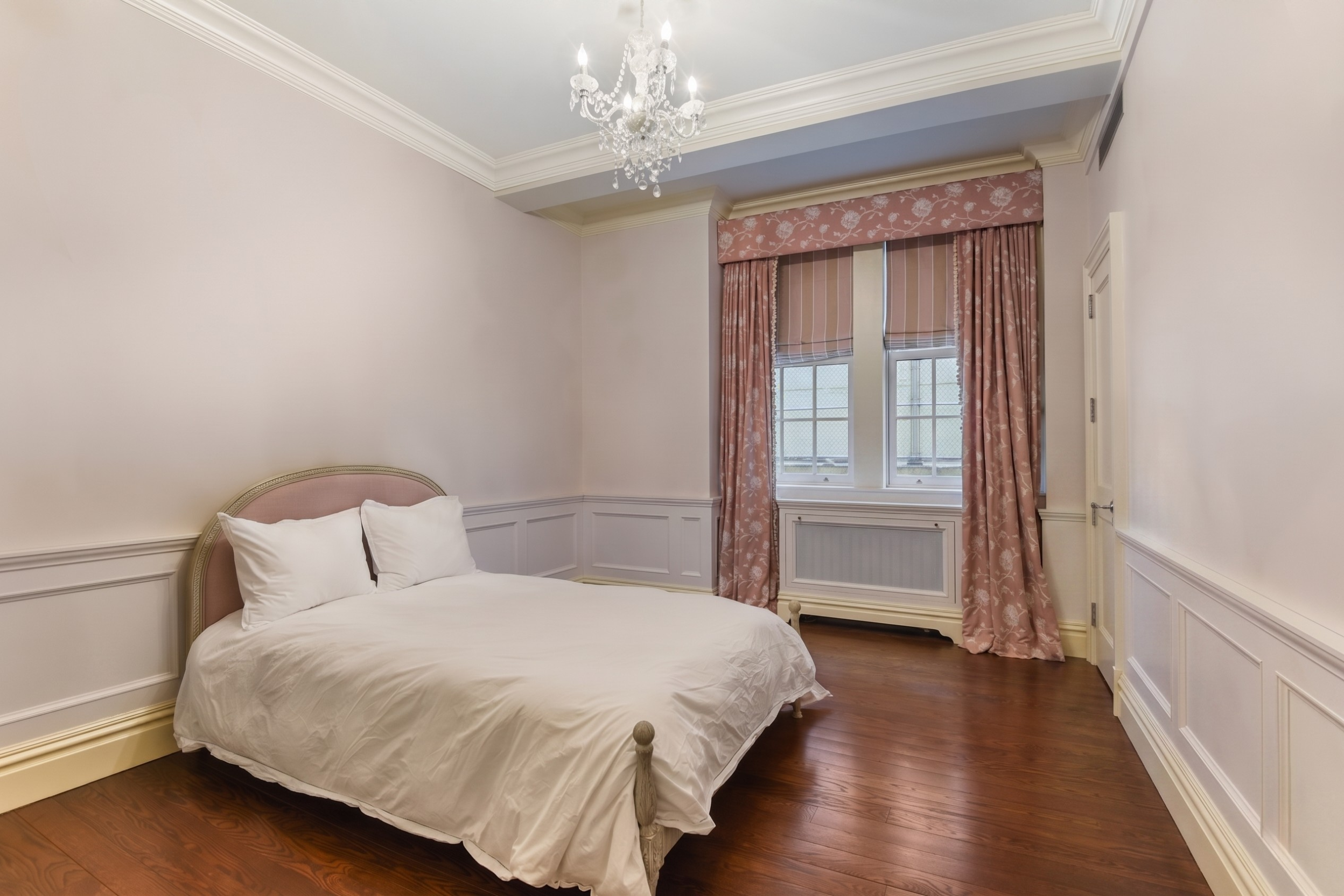435 East 57th Street, Unit 1CD Manhattan, NY 10022 - Photo 8 of 15 a bedroom with a large bed and a chandelier