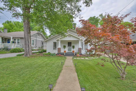 a front view of house with yard and green space