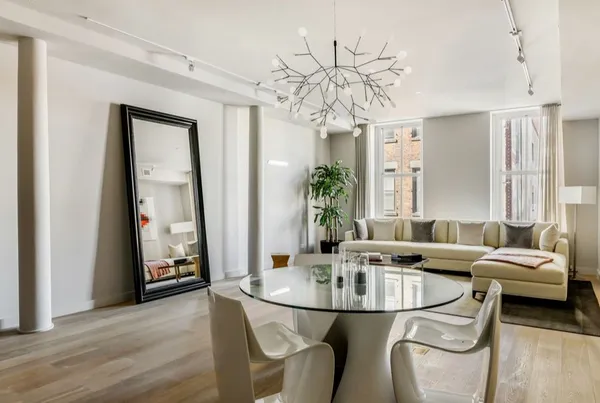 a dining room with furniture and wooden floor