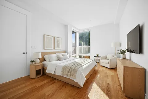 a bedroom with a bed and a flat screen tv