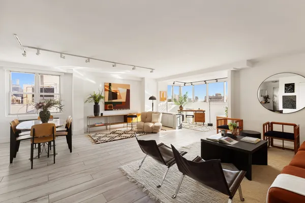 a living room with fireplace furniture and wooden floor