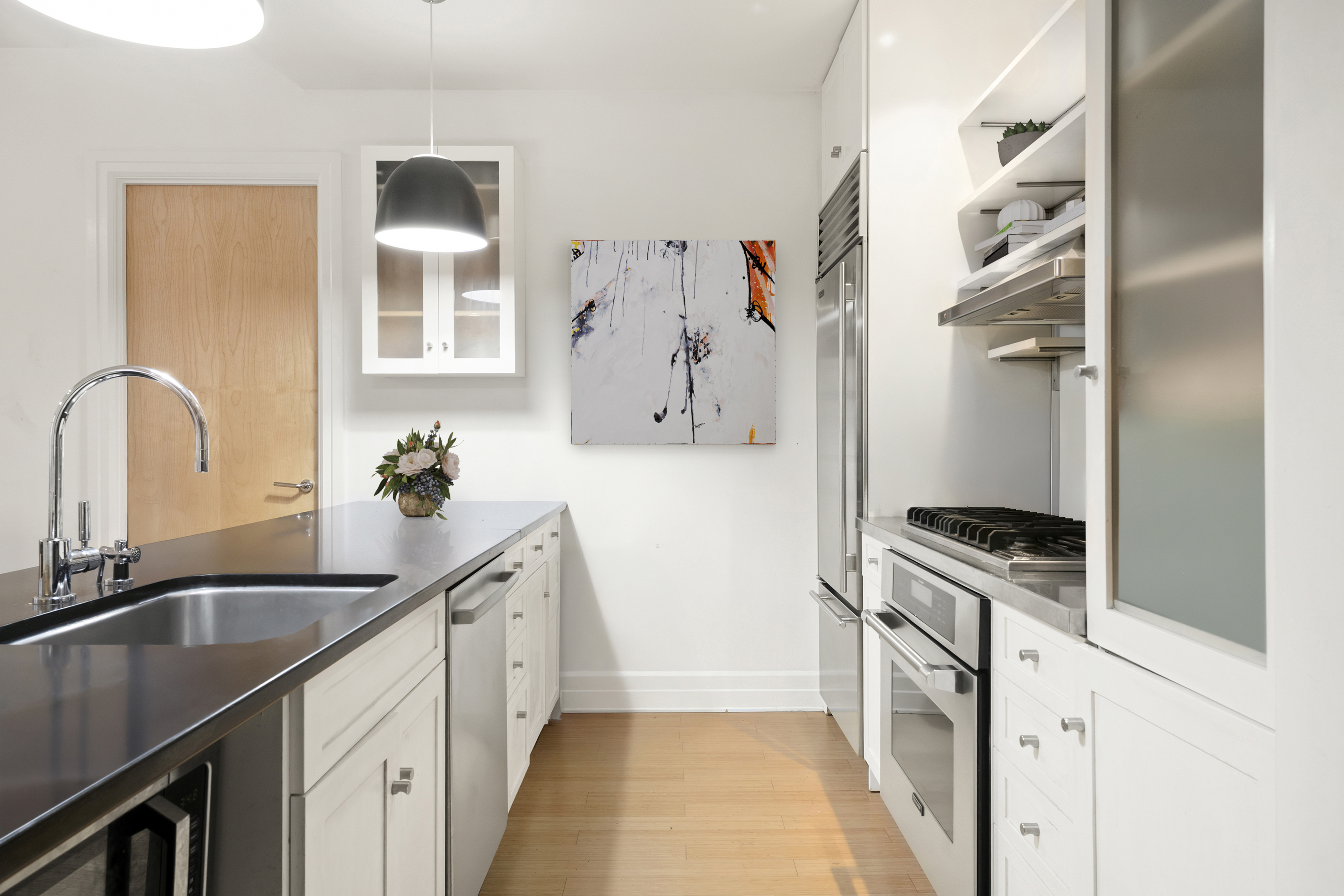 110 Livingston Street, Unit 7D Brooklyn, NY 11201 - Photo 3 of 13 a kitchen with granite countertop a sink stove and refrigerator