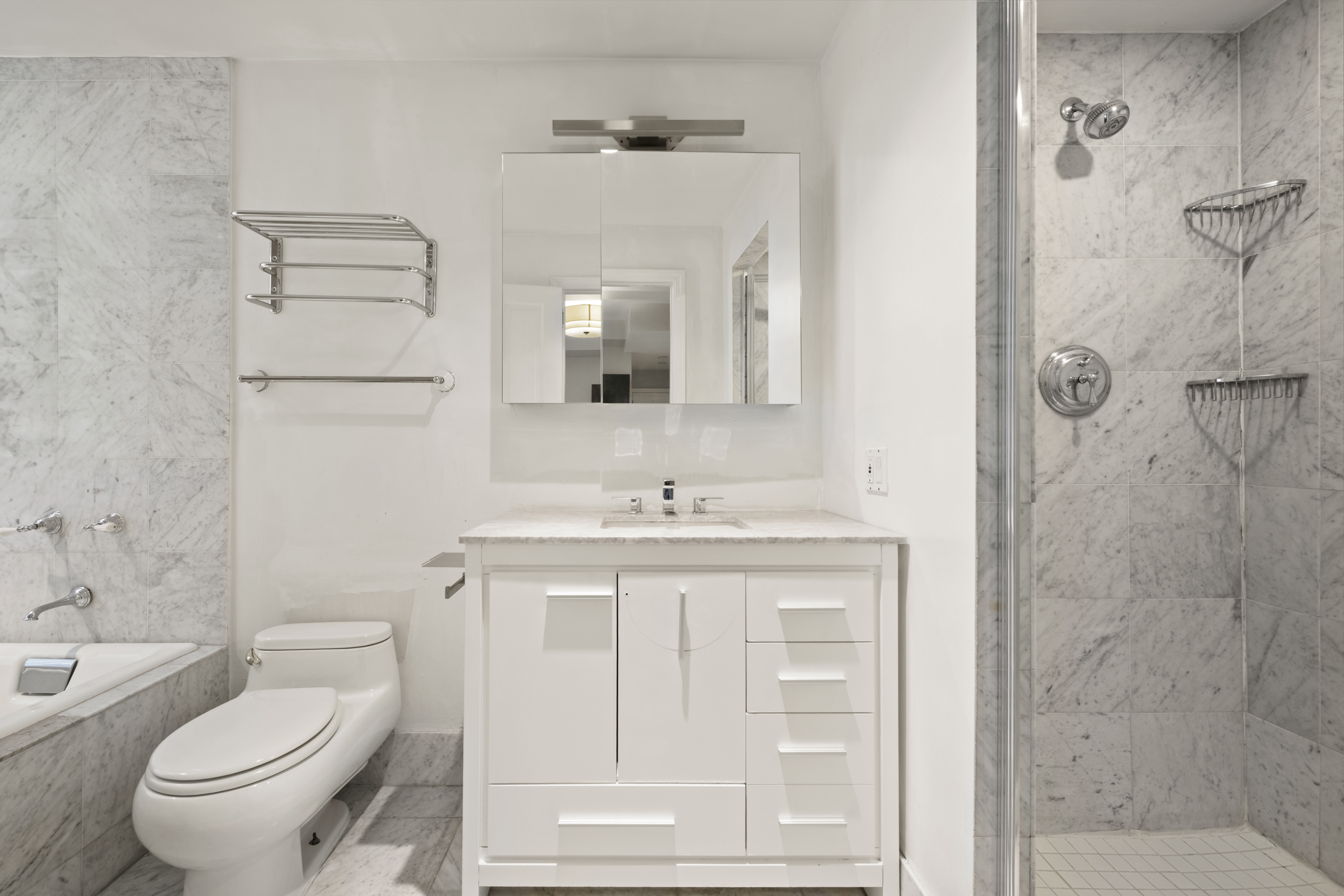 545 West End Avenue, Unit 7C Manhattan, NY 10024 - Photo 7 of 11 a bathroom with a granite countertop sink a toilet and shower
