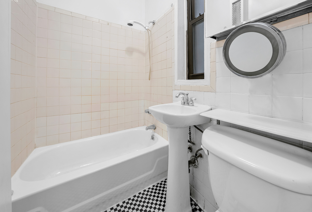 112 East 98th Street, Unit 4W Manhattan, NY 10029 - Photo 5 of 6 a bathroom with a sink a toilet and a bathtub