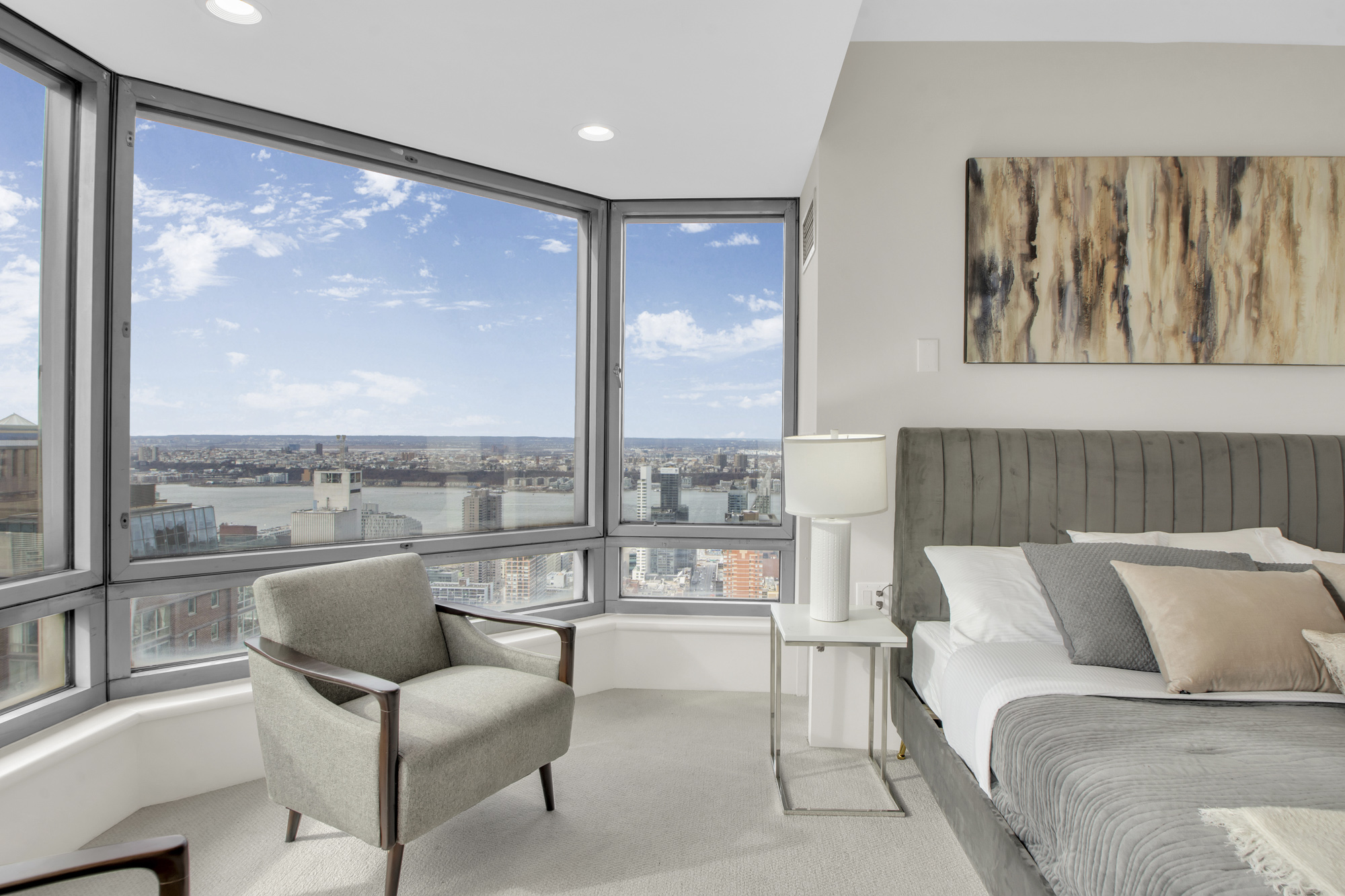301 West 57th Street, Unit 48A Manhattan, NY 10019 - Photo 16 of 22 a living room with furniture and a large window
