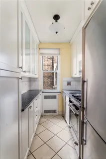 a kitchen with granite countertop a stove sink and cabinets