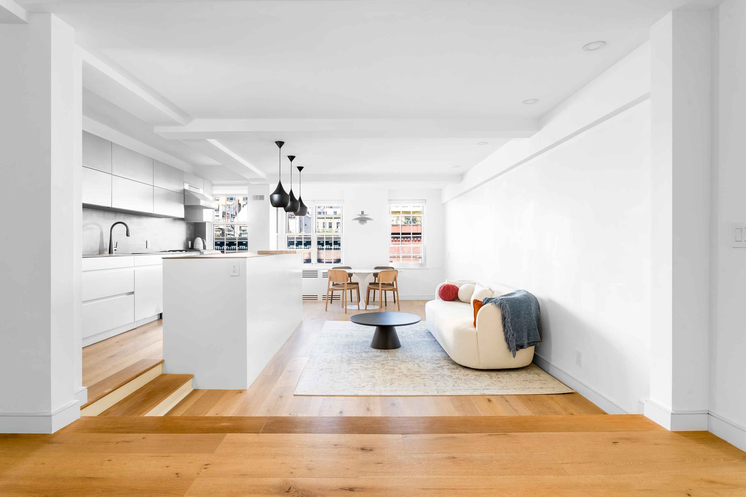 a kitchen with a refrigerator and white cabinets