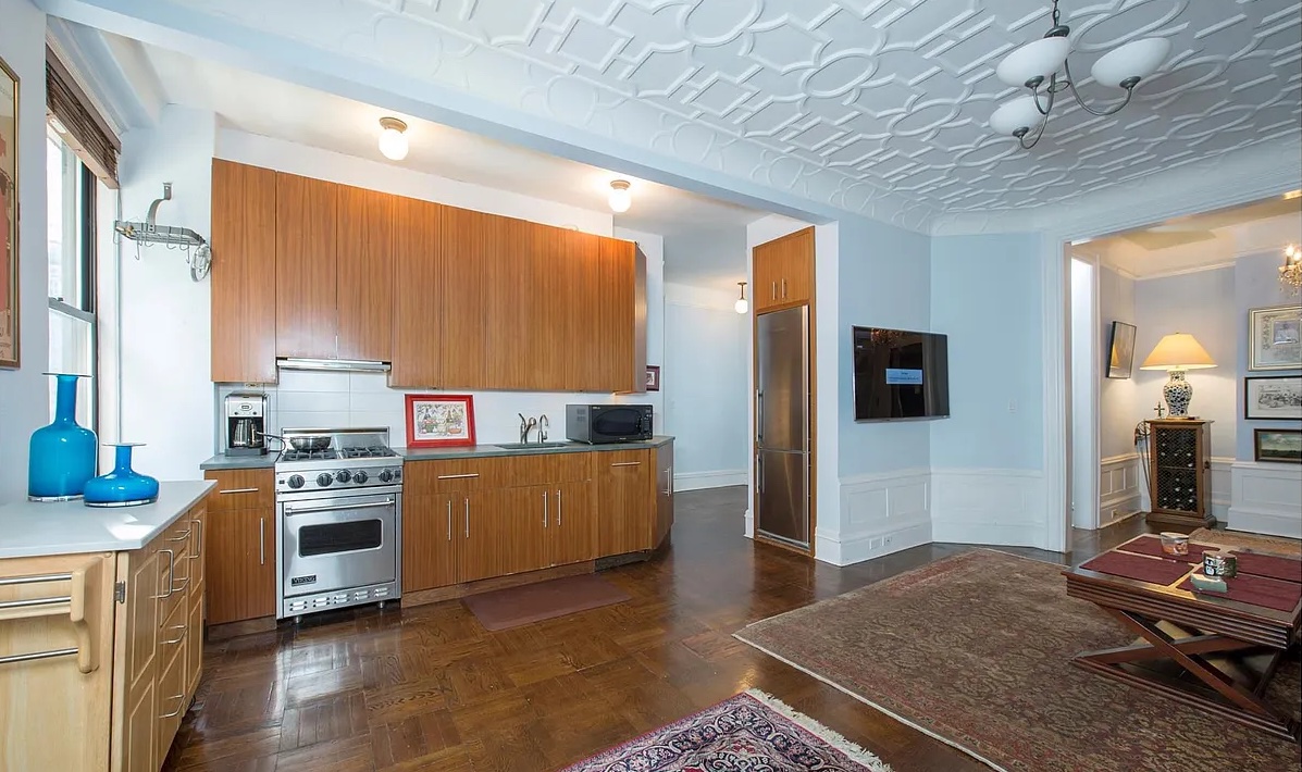 200 West 54th Street, Unit 6D Manhattan, NY 10019 - Photo 2 of 6 a kitchen with stainless steel appliances granite countertop a stove a sink and a refrigerator