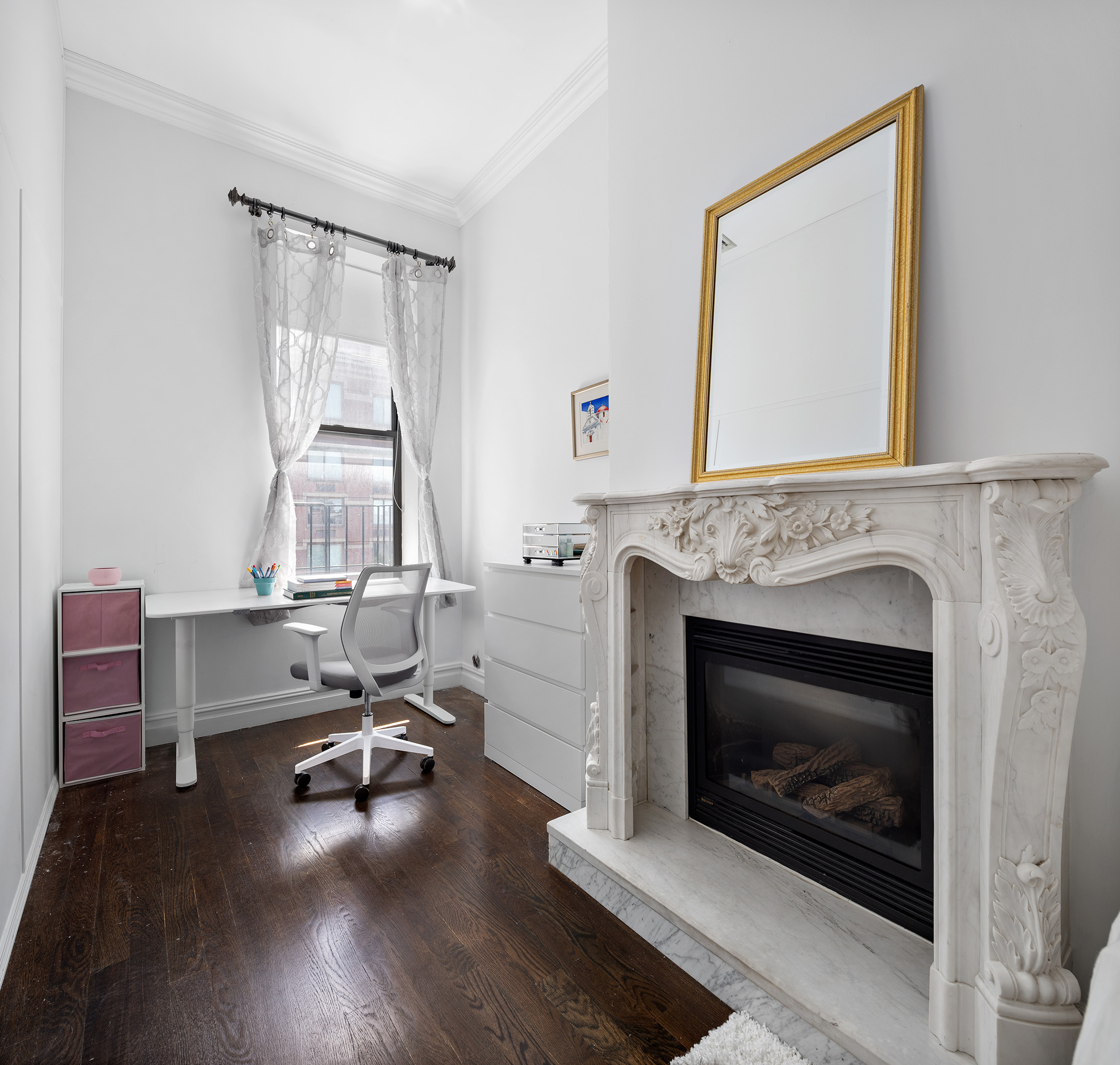 733 9th Avenue, Unit 5 Manhattan, NY 10019 - Photo 7 of 9 a living room with furniture a fireplace and a floor to ceiling window