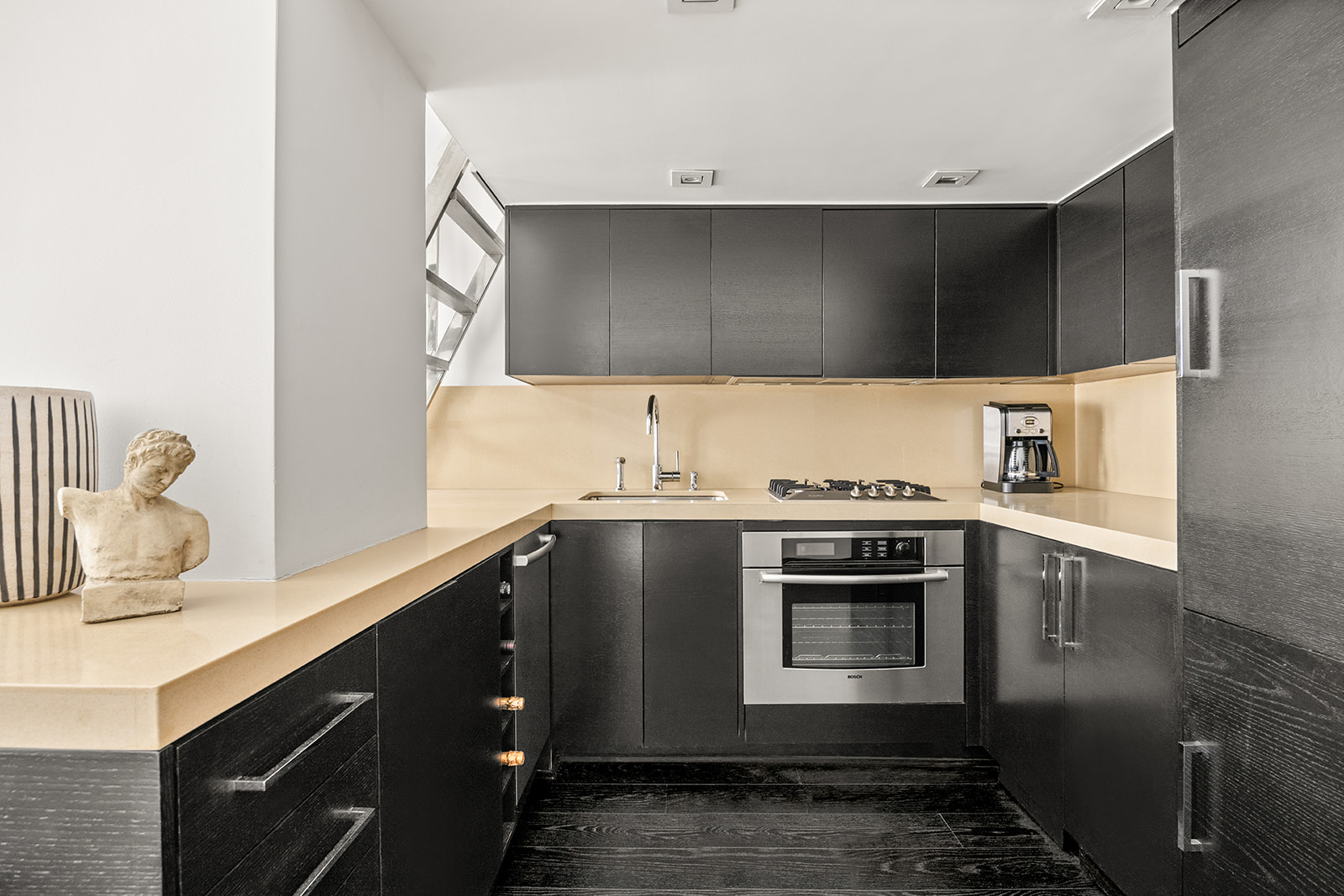 254 Park Avenue South, Unit 4K Manhattan, NY 10010 - Photo 5 of 10 a kitchen with a sink and a stove top oven