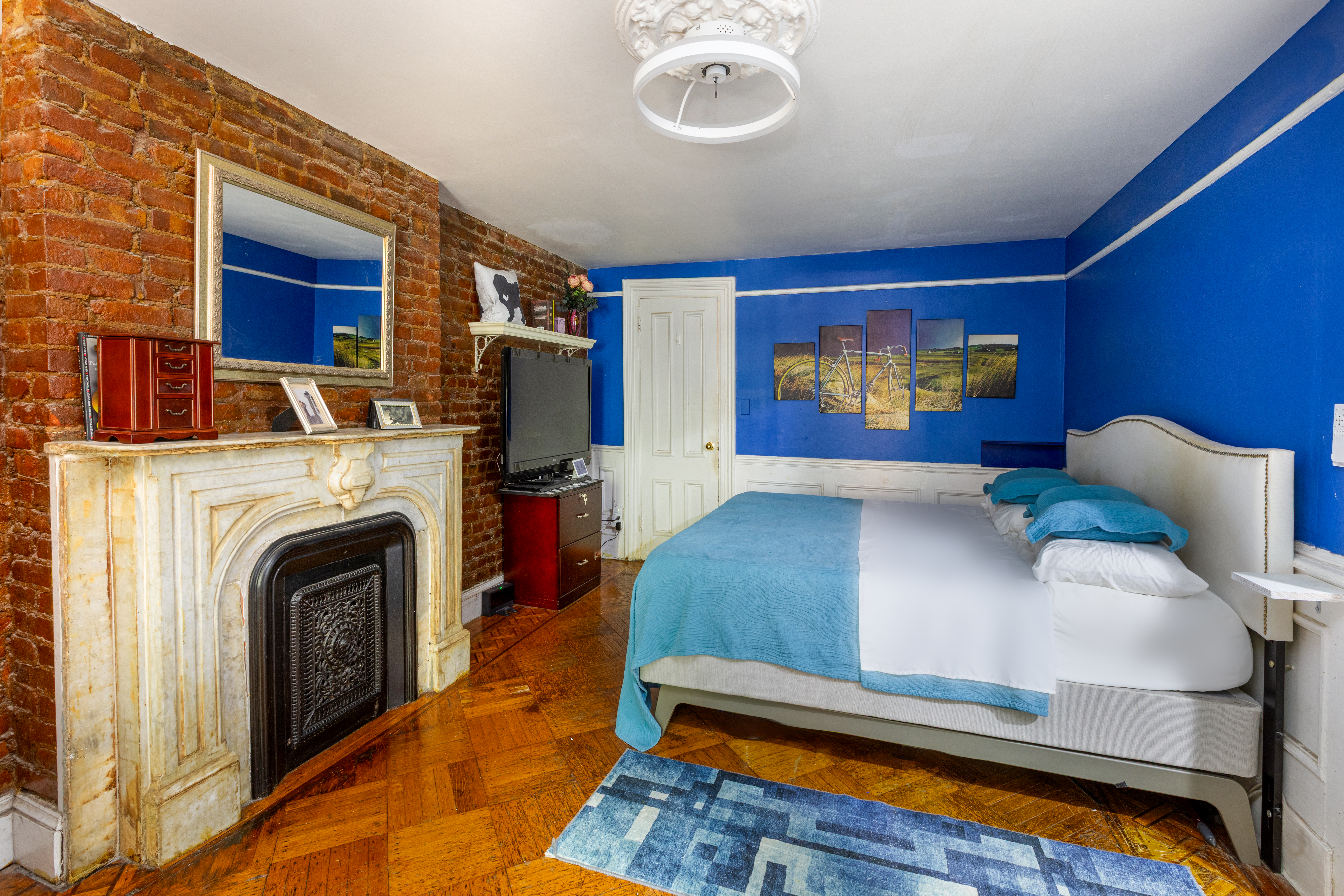 73 Monroe Street Brooklyn, NY 11216 - Photo 6 of 14 a living room with furniture and a fireplace