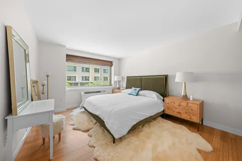 a bedroom with a bed and a large window