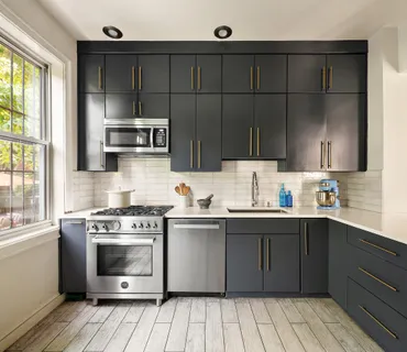 a kitchen with stainless steel appliances a stove sink and cabinets
