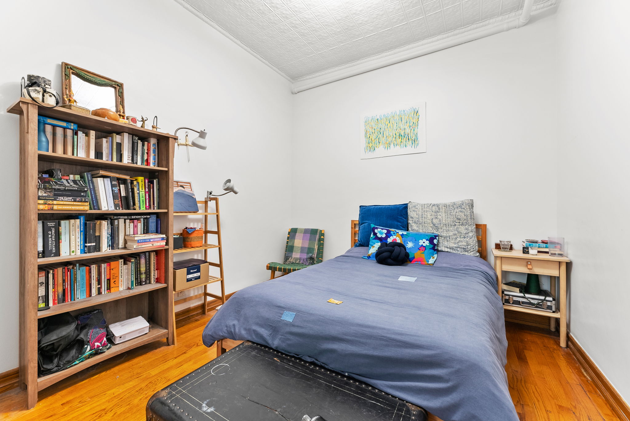 318 11th Street, Unit 1R Brooklyn, NY 11215 - Photo 4 of 7 a bedroom with a bed and a book shelf