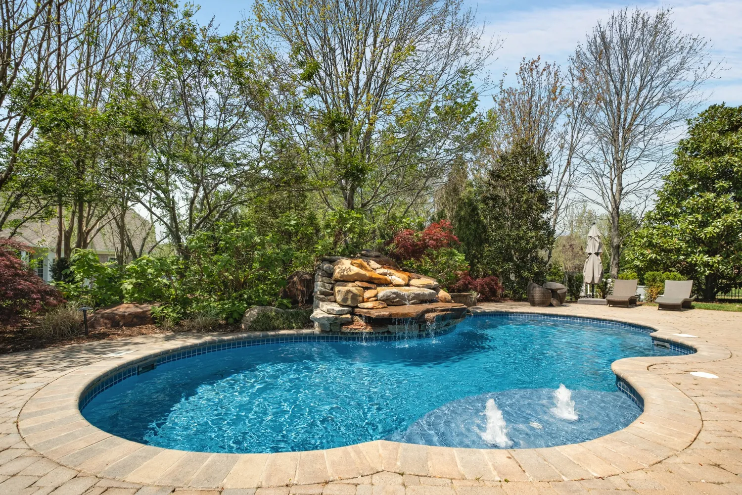 a view of a swimming pool with a yard