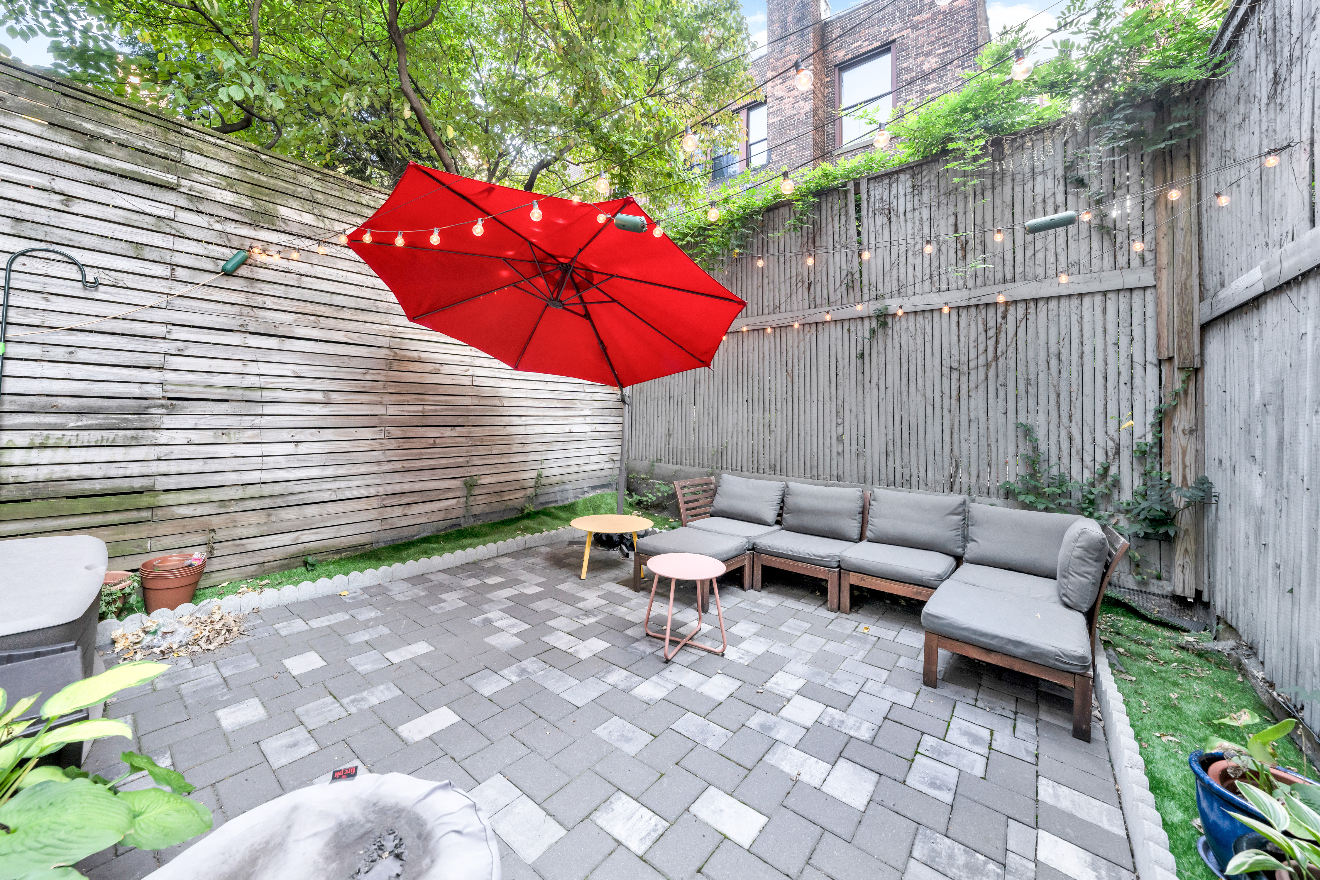 a view of a patio with a table and chairs under an umbrella