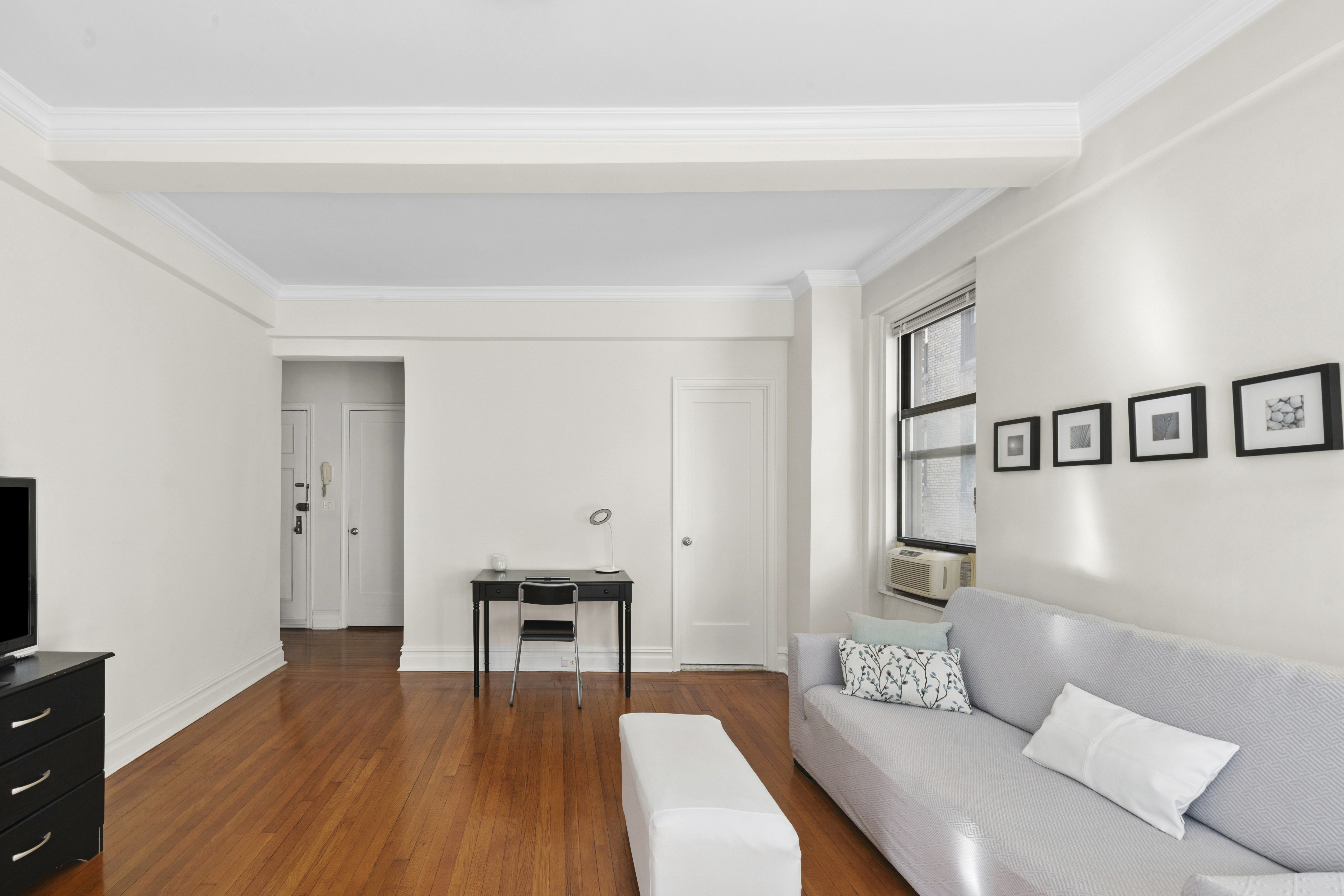 243 West End Avenue, Unit 1104 Manhattan, NY 10023 - Photo 3 of 10 a living room with furniture and a wooden floor