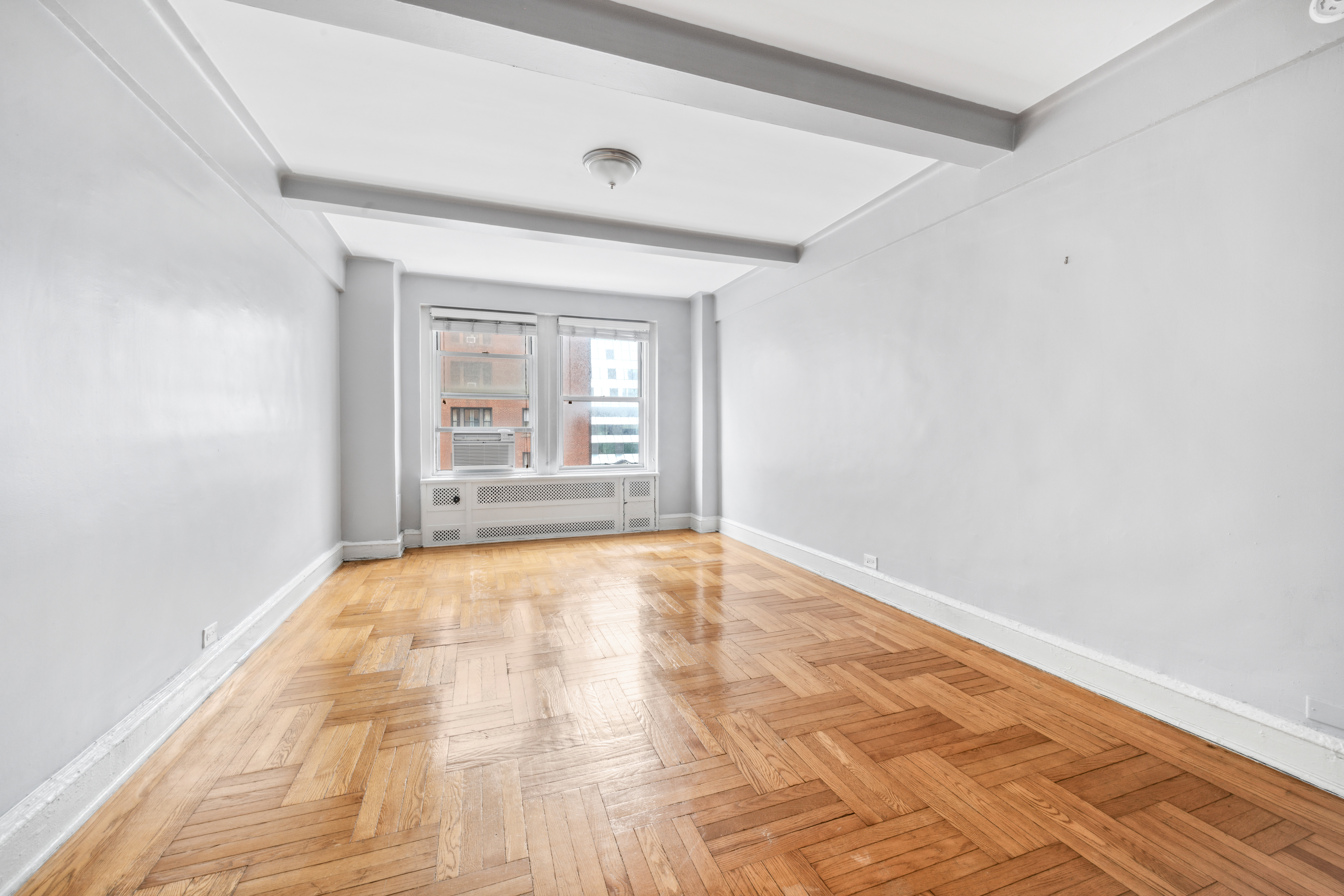 433 West 34th Street, Unit 8D Manhattan, NY 10001 - Photo 4 of 15 wooden floor in an empty room