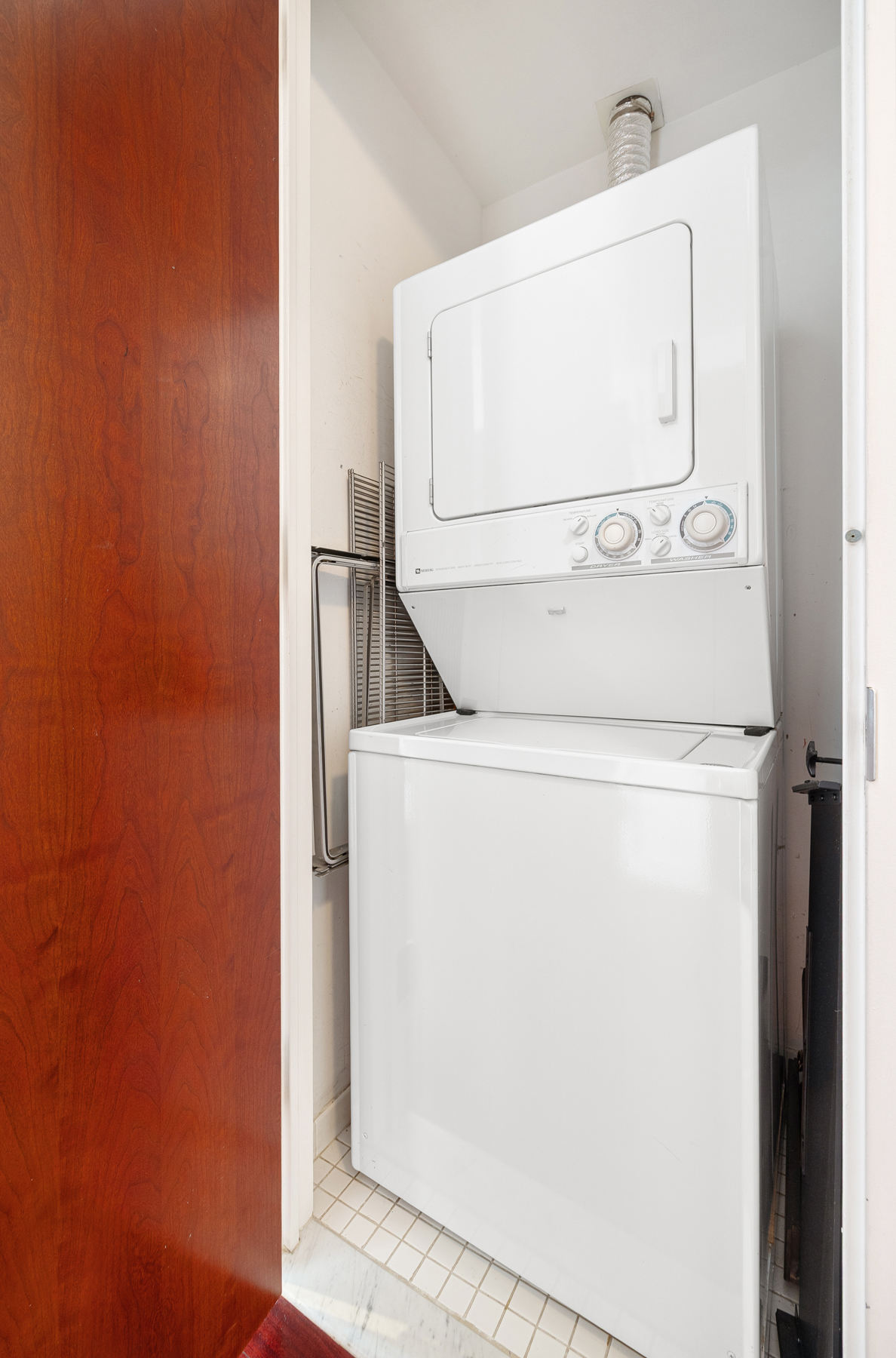 125 West 21st Street, Unit 4C Manhattan, NY 10011 - Photo 9 of 12 a utility room with dryer and washer