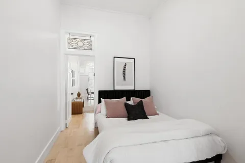 a bed room with a bed and a night stand