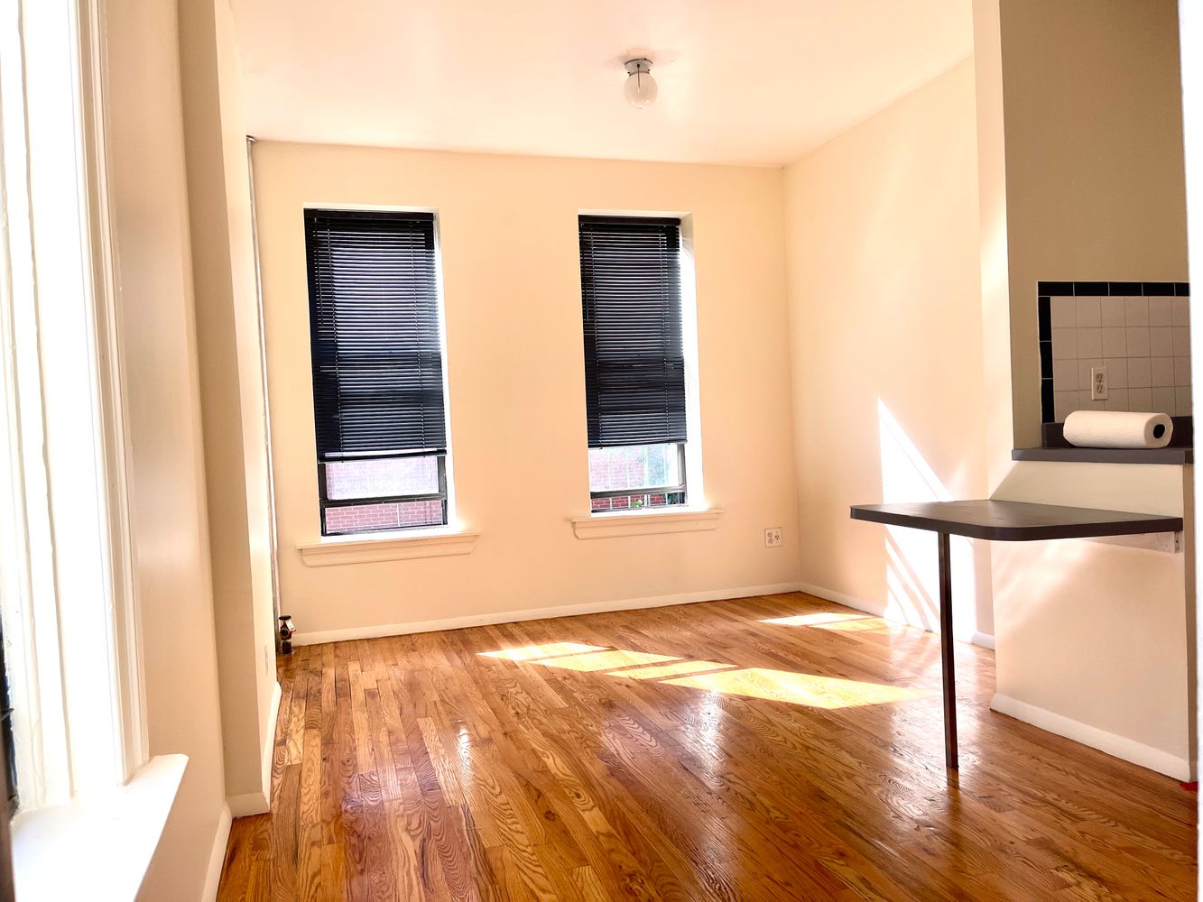 1672 Park Avenue Manhattan, NY 10035 - Photo 26 of 35 a view of an empty room with wooden floor and a window