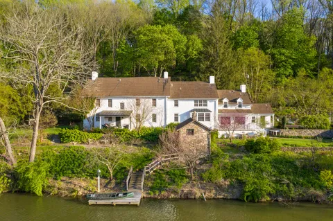 a aerial view of a house with swimming pool garden and patio