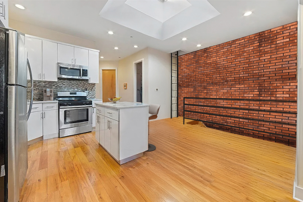 426 Rogers Avenue Brooklyn, NY 11225 - Photo 7 of 9 a kitchen with stainless steel appliances a refrigerator and a stove top oven
