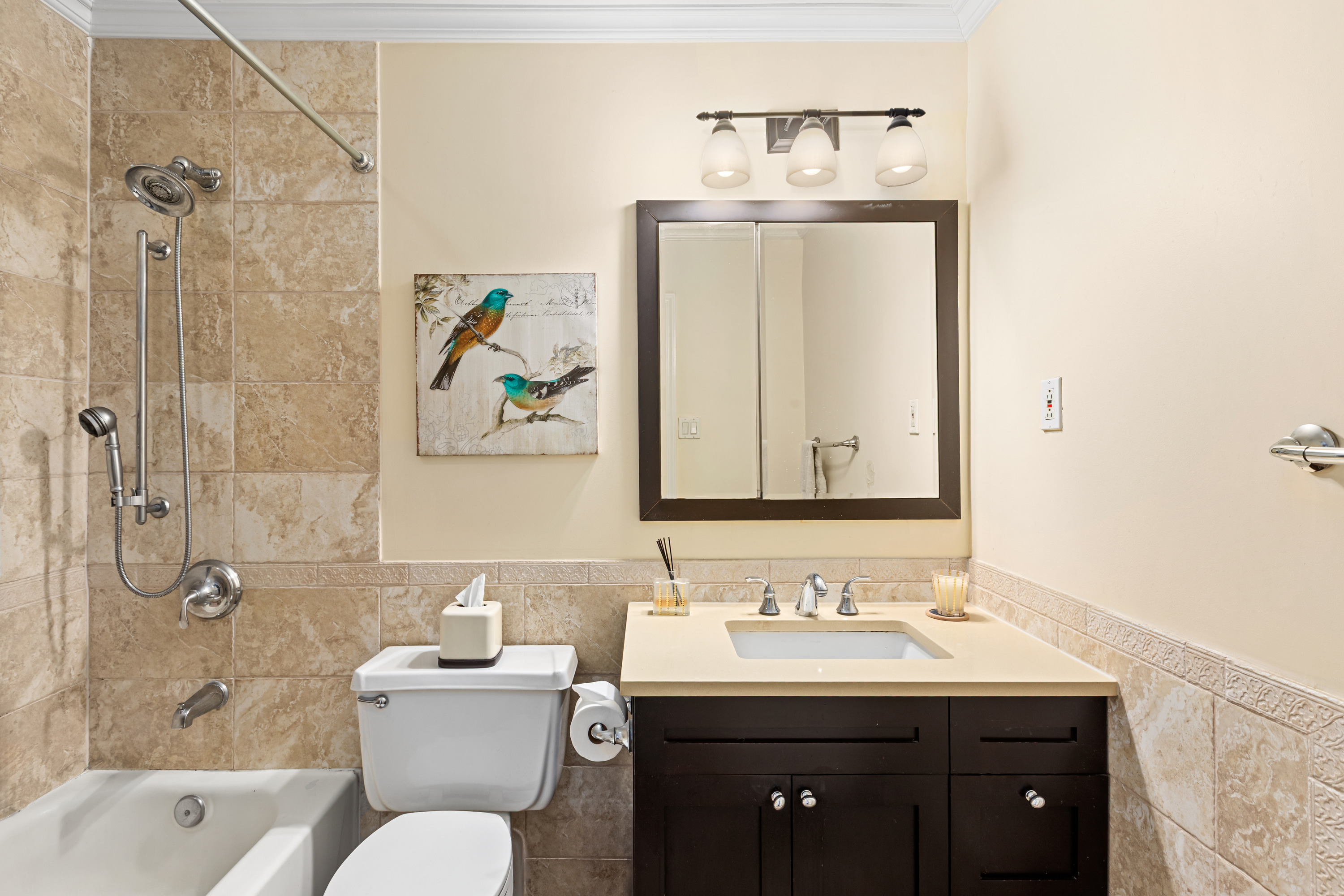 253 West 73rd Street, Unit 9G Manhattan, NY 10023 - Photo 5 of 9 a bathroom with a granite countertop sink toilet and shower