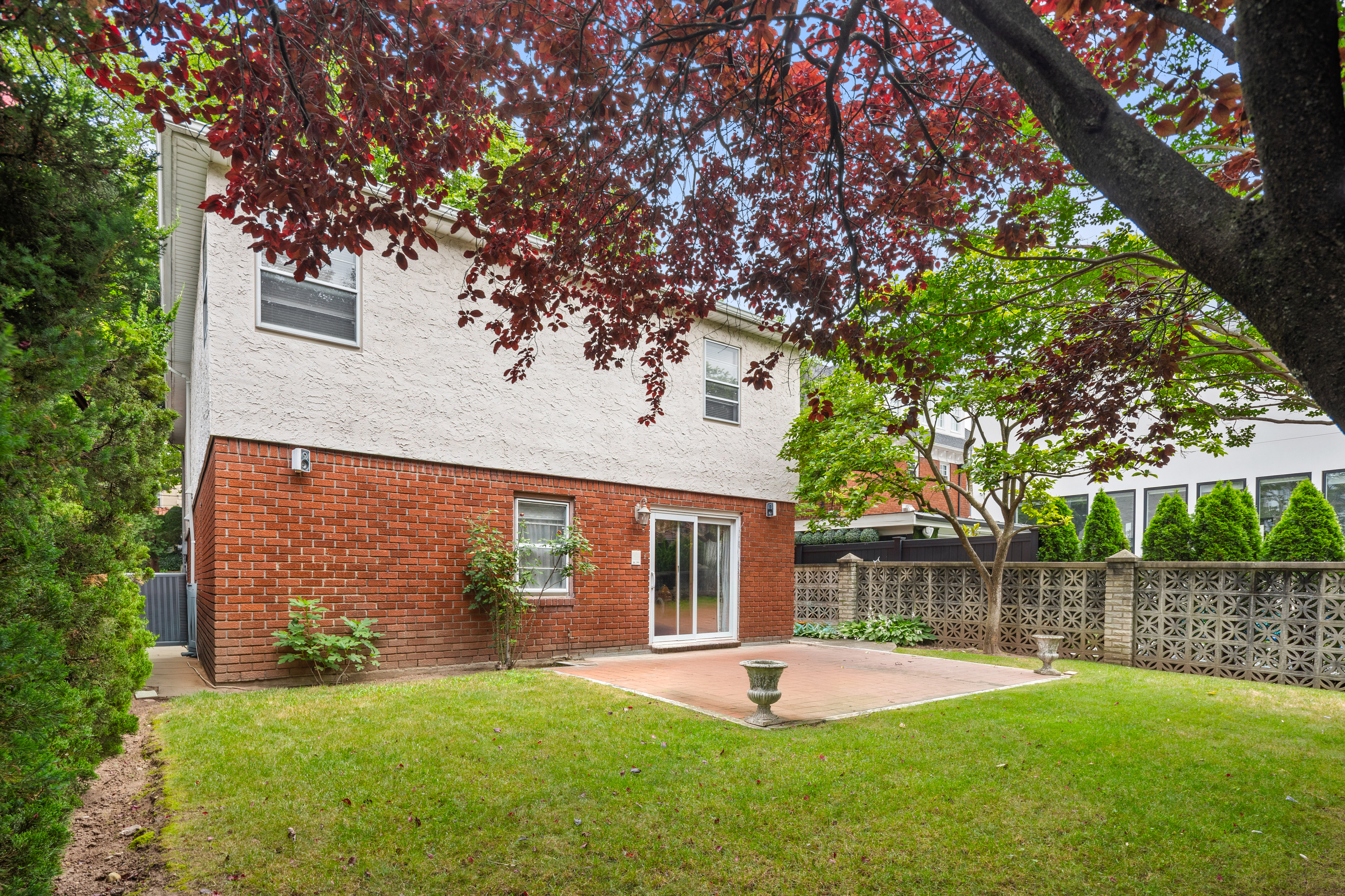 110 82nd Street Brooklyn, NY 11209 - Photo 19 of 28 front view of a house with a yard and a large tree
