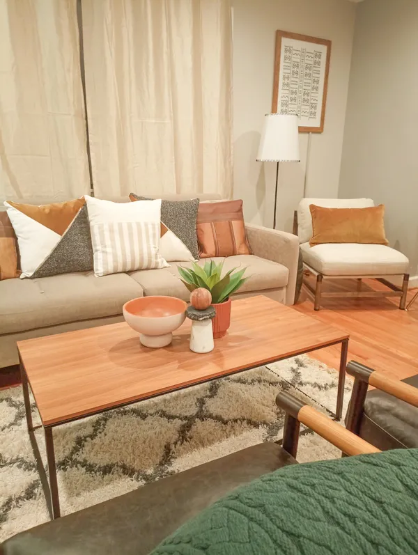 a living room with furniture and a rug