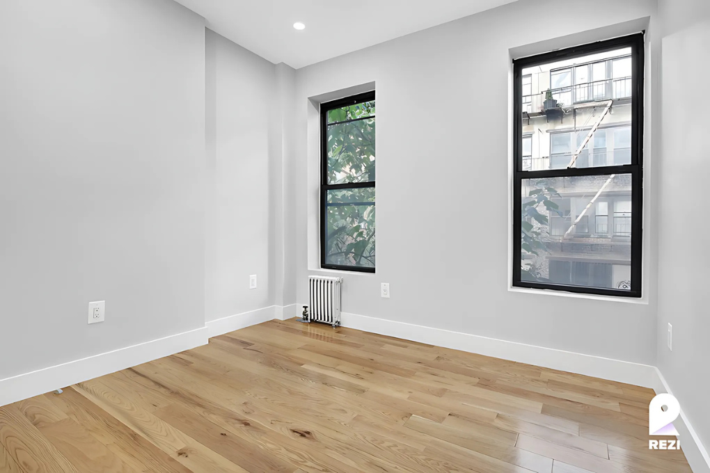 175 East 105th Street, Unit 3R Manhattan, NY 10029 - Photo 4 of 8 an empty room with windows and closet