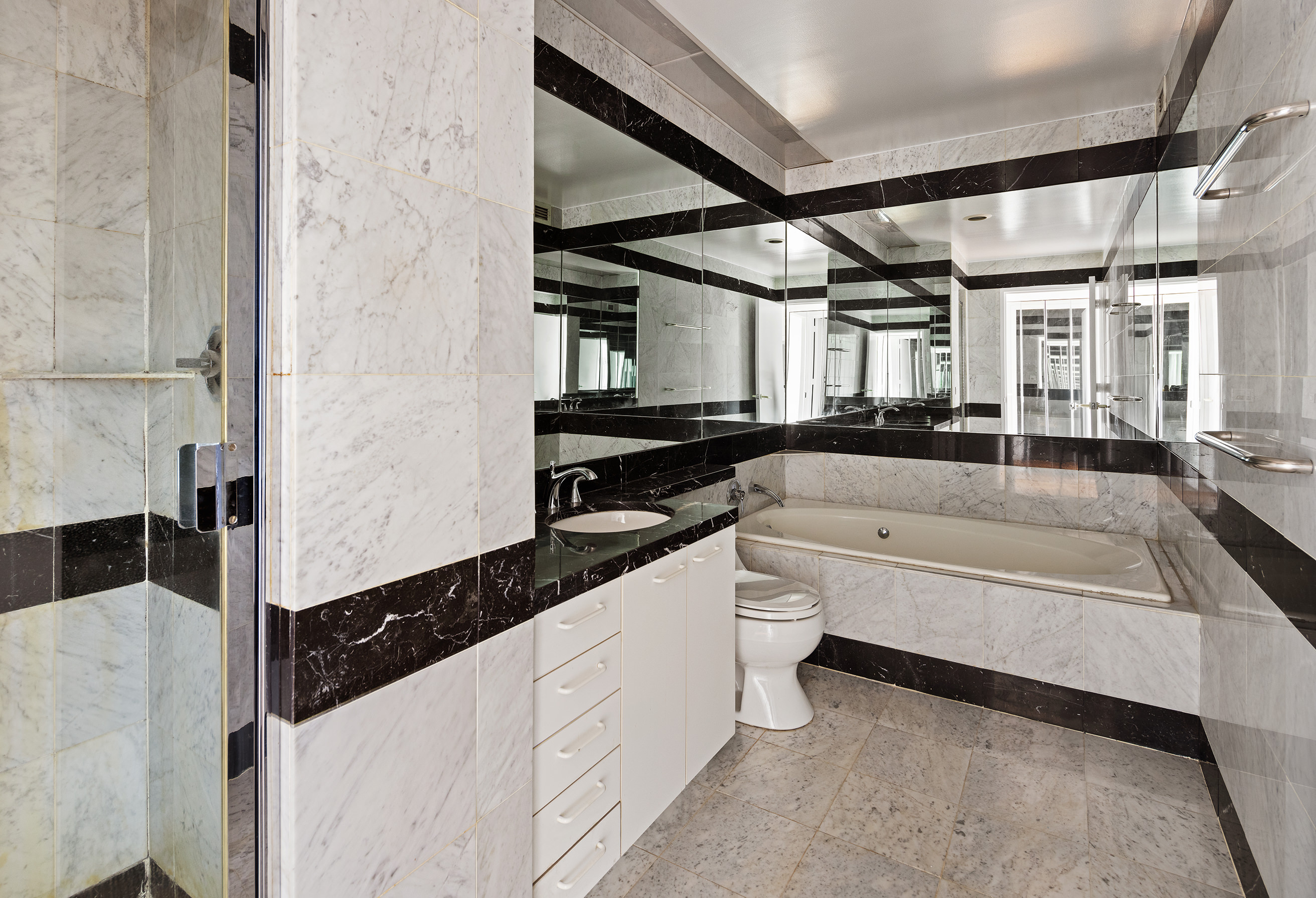 150 West 56th Street, Unit 6204 Manhattan, NY 10019 - Photo 11 of 15 a large white kitchen with a large window
