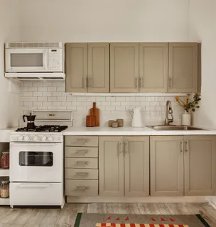 a kitchen with white cabinets and white appliances