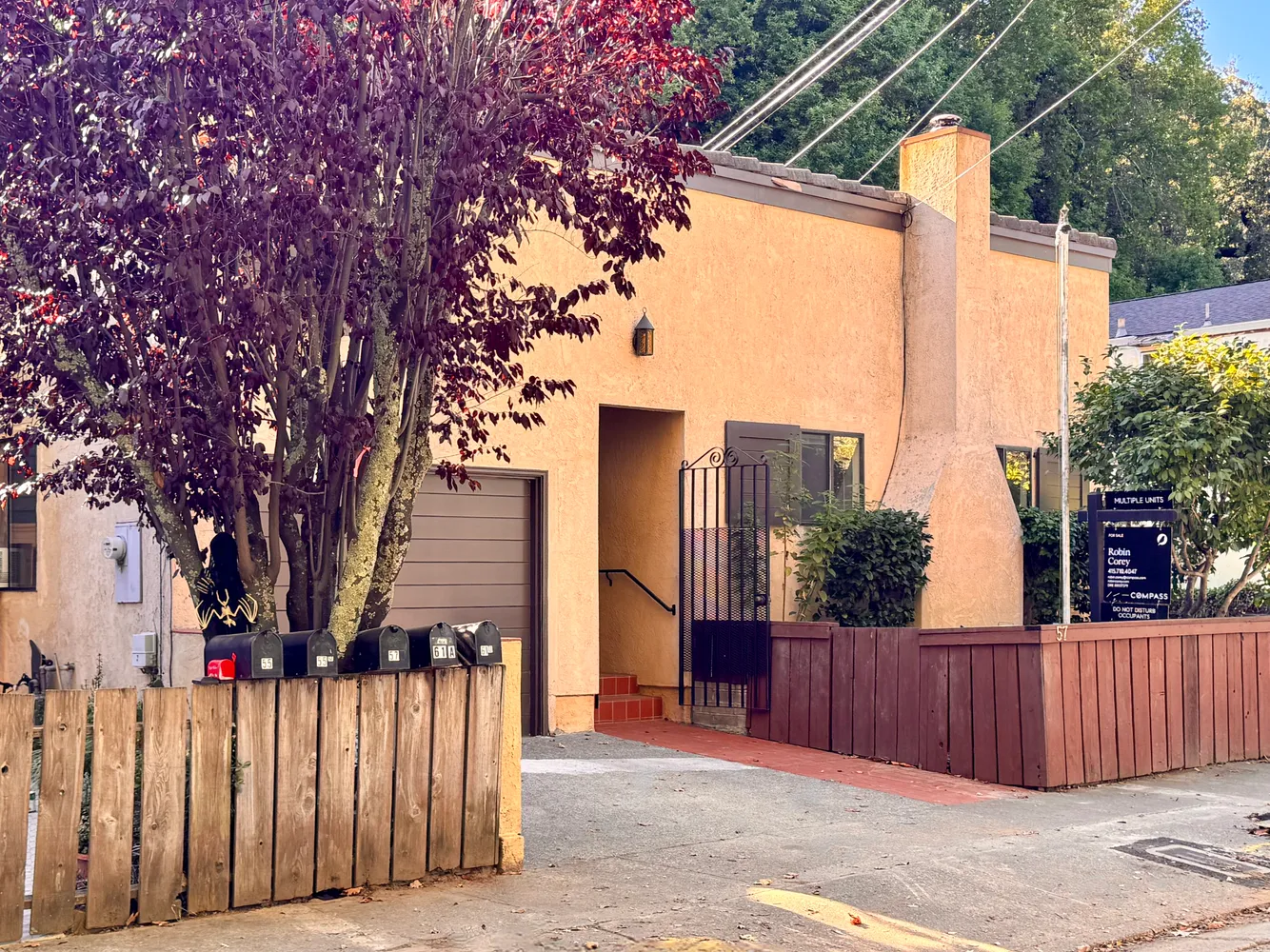 a front view of a house with wooden fence