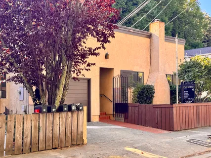 a front view of a house with wooden fence