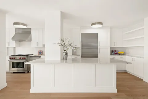 a kitchen with stainless steel appliances cabinets and a counter top space