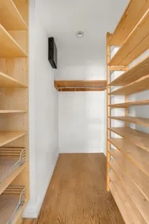 a view of walk in closet with empty racks